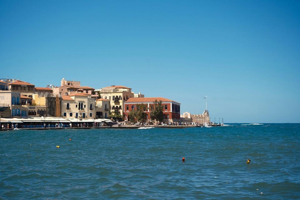 The colourful waterfront houses of Chania's Venetian harbour on a sunny day